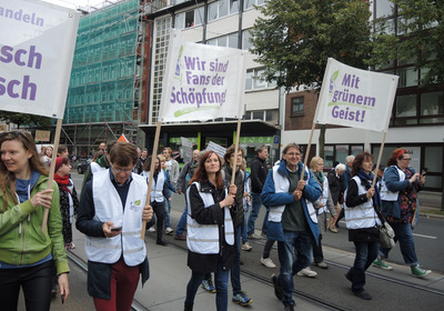 Eine Straßendemonstration zum Klimaschutz. Transparente beinhalten die Aufschrift "Wir sind Fans der Schöpfung!" und "Mit grünem Geist!"