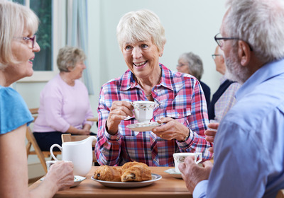 fröhliche Seniorinnen beim Kaffee