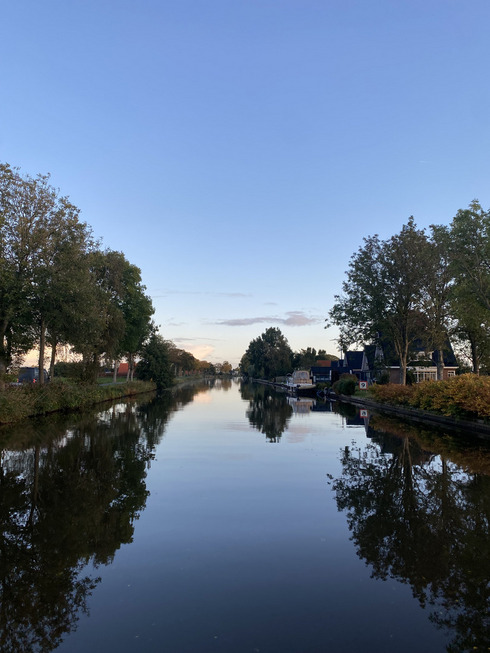 Ein Kanal mit absolut stillem Wasser und einem Sonnenaufgang.