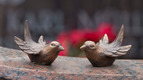 Skulpturen von zwei kleinen Vögeln auf dem Friedhofsgelände