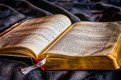 Das Foto zeigt ein altes Gesangbuch auf einem blauen Samttuch